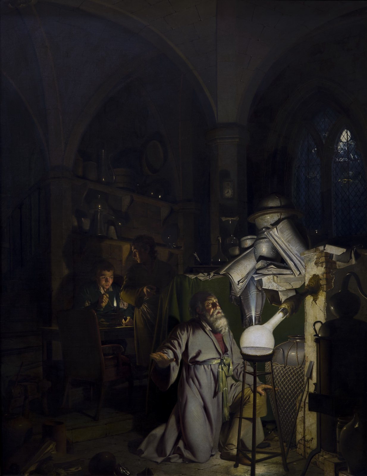 Joseph Wright of Derby's alchemist kneels before a glowing flask while two assistants work in shadow.
